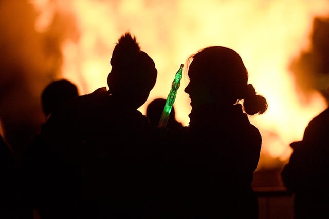 A mum and daughter enjoy the fire