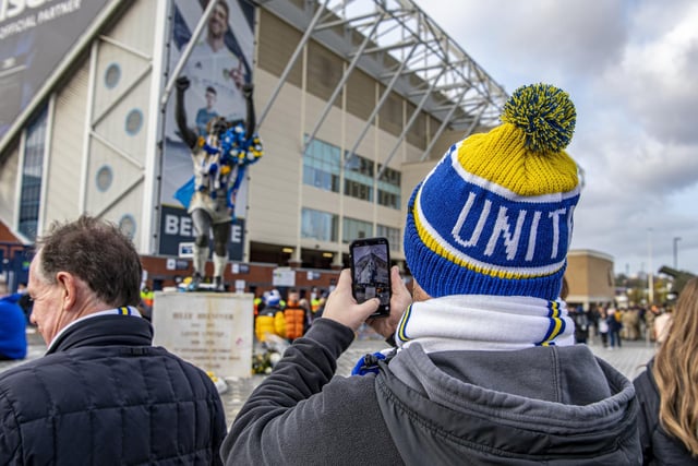 A Leeds United fan snaps Billy Bremner ahead of kick-off.
