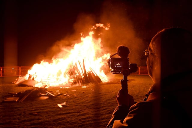 Pictured filming the bonfire