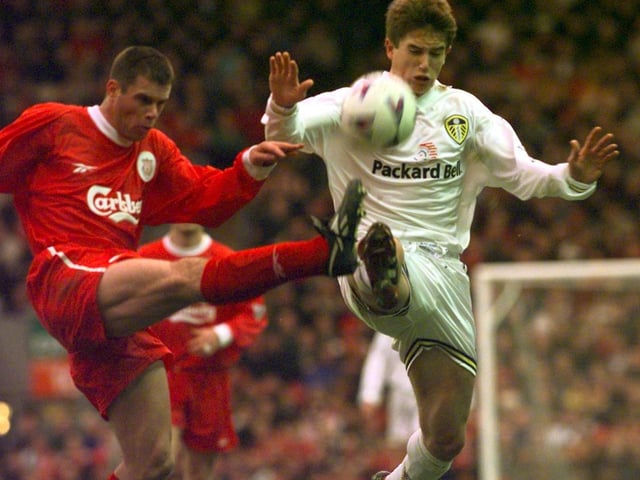 Liverpool's Jamie Carragher clears the ball under pressure from Harry Kewell.