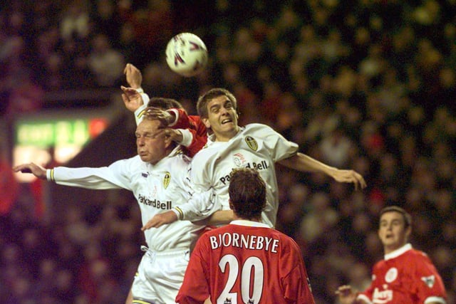 Robert Molenaar and Jonathon Woodgate rise high to clear the danger of a Liverpool attack.