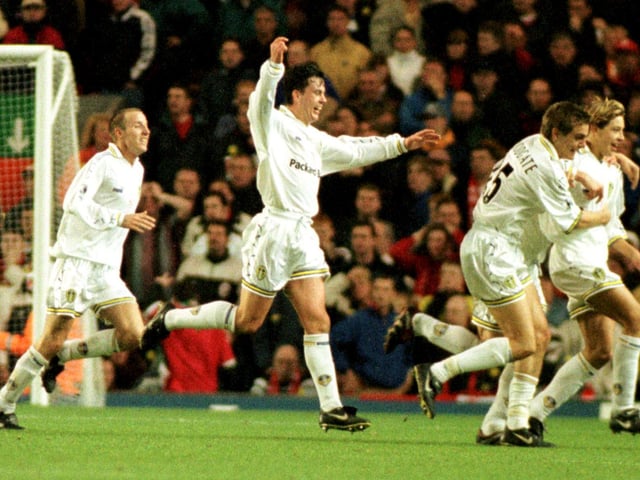 Alan Smith is mobbed by his teammates after coming off the bench to score.
