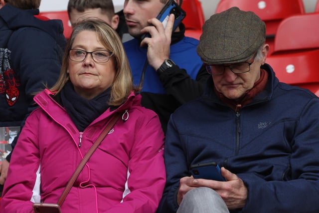 Two Preston fans in the away end at the City Ground before kick-off