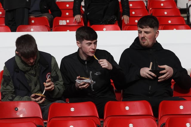 A trio of young PNE fans tuck into their pre-match pies