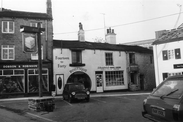 Bondgate in 1976 showing leather goods and sports goods shop Dobson & Robinson, Fourteen to Forty boutique, Wharfedale Model Centre, Champion & Woolley, plumbing and heating, and The Woolpack pub.