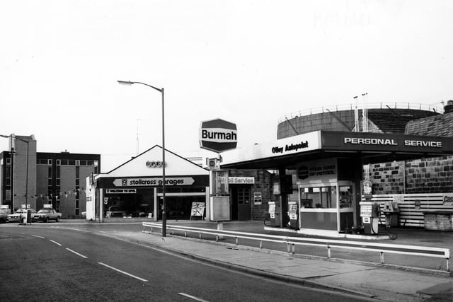 Gay Lane showing Otley Autopoint Petrol Filling Station in July 1979.  Beside this is the junction with Wellcroft, with Stollcross Garages car showroom beyond. In the background on the right, a gasometer can be seen.