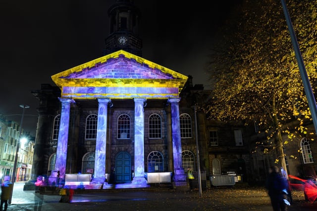 Lighting changes the facade of a building in the Market Square as part of Light Up Lancaster 2021. Photo: Kelvin Stuttard