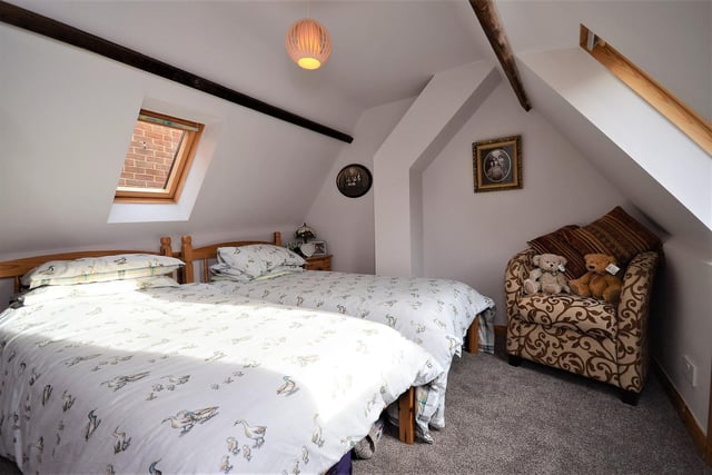 A top bedroom with ceiling brams and character.