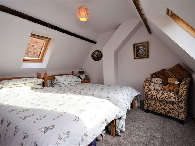A top bedroom with ceiling brams and character.