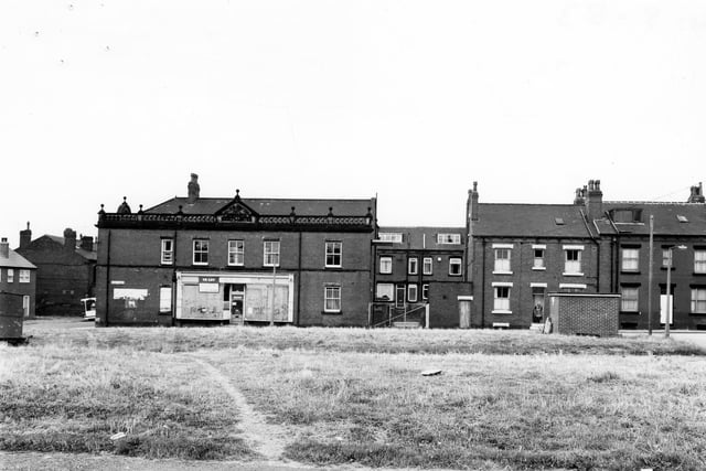 Hardy Street from the former Stewart Place in August 1983. The two areas of grass were once the site of red brick streets Ellis Place and Stewart Place, foreground. The building with shop frontage is the former Co-op