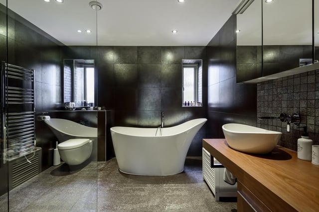 The stunning house bathroom boasts a volcanic limestone stand-alone bath.
