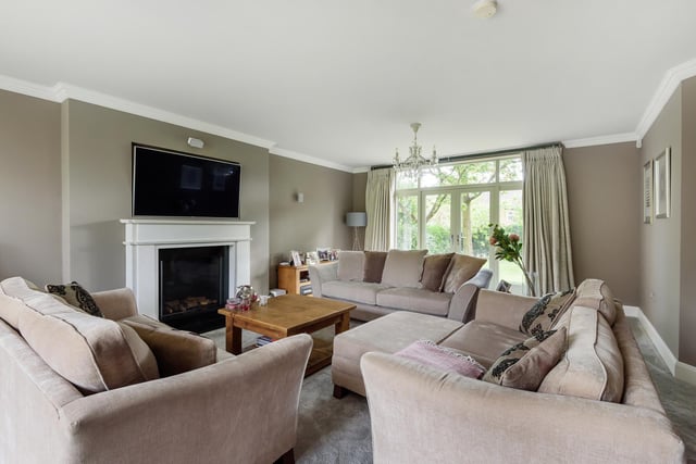 The elegant sitting room with central feature fireplace and doors to the garden.