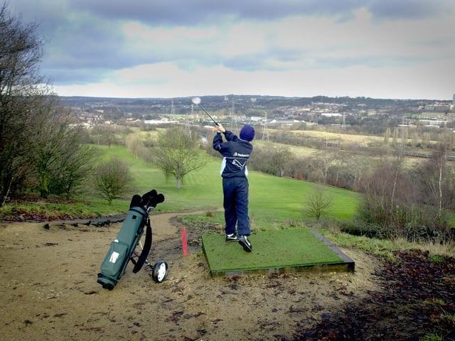Luke Whitaker tees off on the first hole at Gotts Park golf course in January 2001.