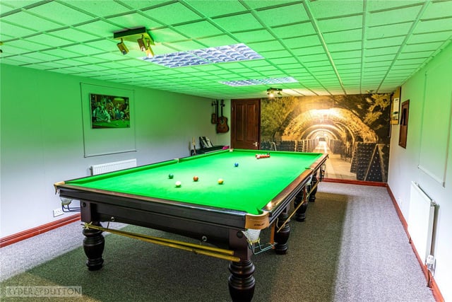 A full size snooker table takes pride of place in this lower ground floor room.