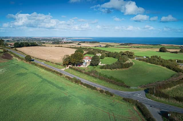 Fields and countryside surround the Reighton property, with the sea beyond.