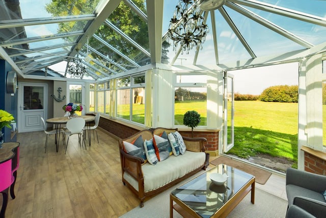 A lovely, relaxing conservatory with doors out to the expansive gardens.