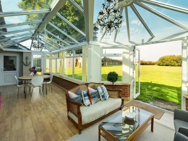A lovely, relaxing conservatory with doors out to the expansive gardens.