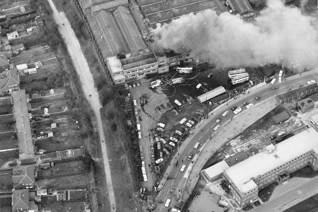 An aerial view of Cross Gates Carriage Works on Manston Lane, the firm of Charles H. Roe. A small fire in March 1975 is being attended to by several engines. Nine metro buses worth £120,000 each had to be pushed to safety.