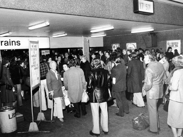 Passengers wait at the barriers in Leeds City Station after a bomb alert in November 1975.