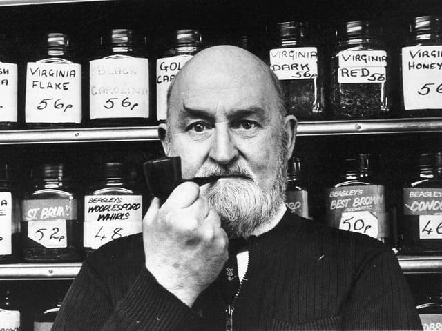 This is Jack Beasley pictured in his tobacconist shop in March 1975. He sold more than 38 of his own pipe mixes as well as other makes and tobacco for the "roll your own" man.