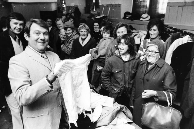 Comedian Terry Scott shares a joke when opening a bargain sale held by the Pudsey branch of the Save the Children Fund at the town's Unitarian Church in November 1975.