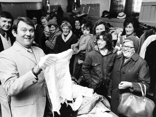 Comedian Terry Scott shares a joke when opening a bargain sale held by the Pudsey branch of the Save the Children Fund at the town's Unitarian Church in November 1975.