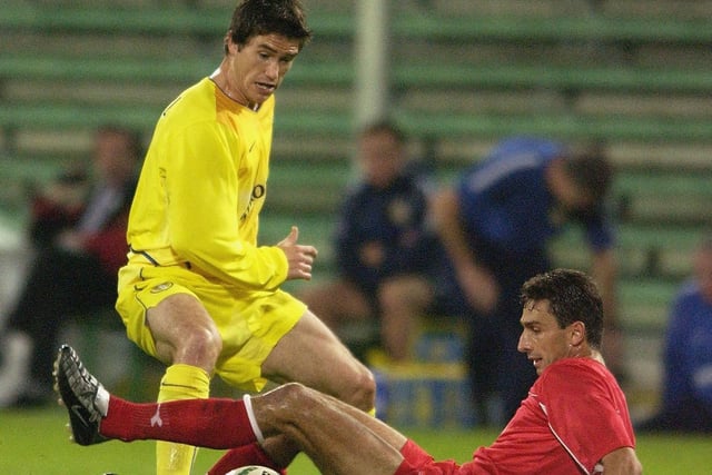 Harry Kewell is tackled by Hapoel Tel Aviv's Shimon Gerson.