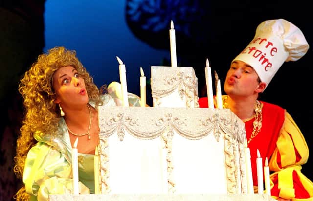 Sleeping Beauty Lisa Shingler, and the Knave Daniel Copeland blowing out the candles on her 18th birthday cake, part of the Pantomime Sleeping Beauty.