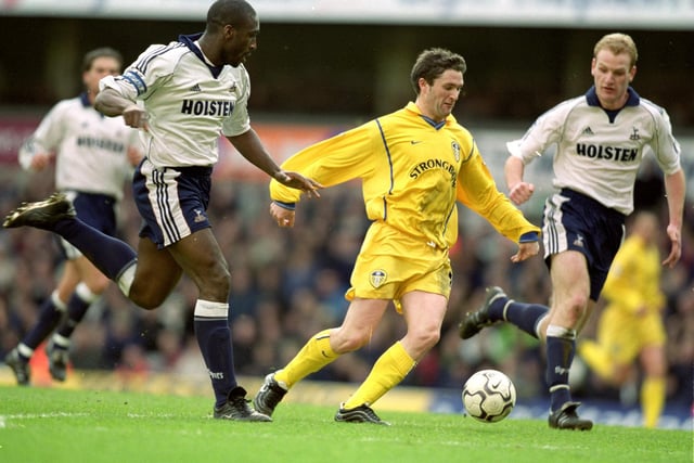 Robbie Keane is chased by Sol Campbell.