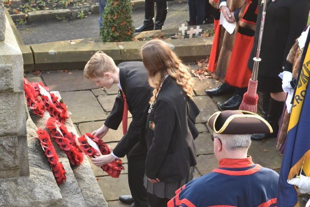 Ribblesdale Head boy and head girl lay a wreath. Picture by Ken Geddes