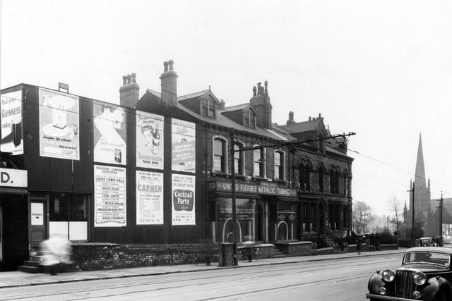 Woodhouse Lane in February 1953. Blenheim Terrace, Trinity Congregational Church on right. Advertising hoardings for Guinness, Electricity, Lux, Sanatogen and Walls sausages can clearly be seen. There are also playbills for Leeds Town Hall and Civic Theatre.