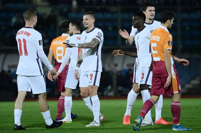 ALL SMILES: Kalvin Phillips heads to celebrate with Emile Smith-Rowe during Monday's 10-0 rout of San Marino. Photo by FILIPPO MONTEFORTE/AFP via Getty Images.