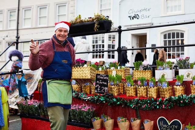 A man at his stall of festive plants at the market in 2018.