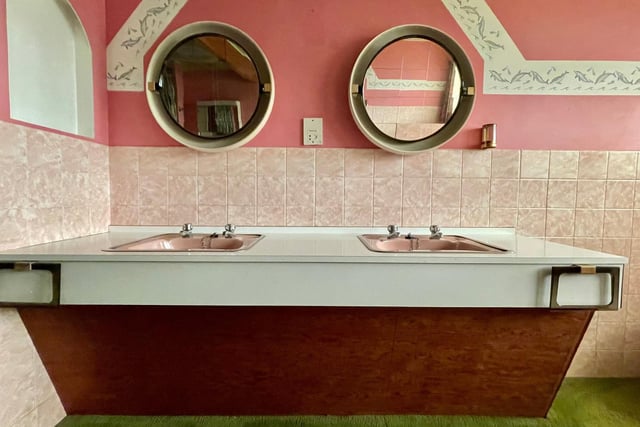 This Whisper Pink bathroom has double sinks and a mirror each