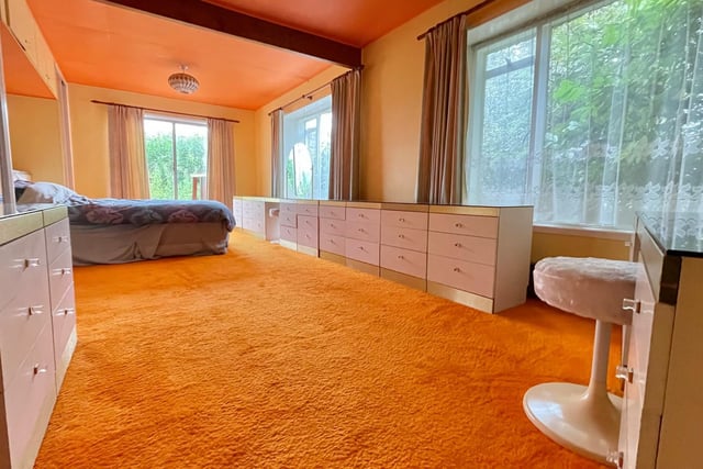 This enormous main bedroom is pure Sixties with orange carpet, stil immaculate. The estate agent refers to it as a "Bond style room"
