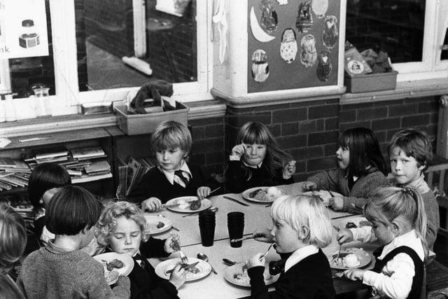 Children tucking into their school dinners