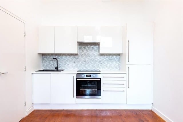 The kitchen has wall and base units, gas hob with electric oven and extractor over, integrated fridge freezer, plumbing for a washing machine and ample space for a dining table.