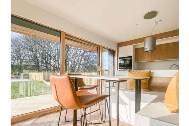 The sleek space offers stunning views over the garden and surrounding countryside.