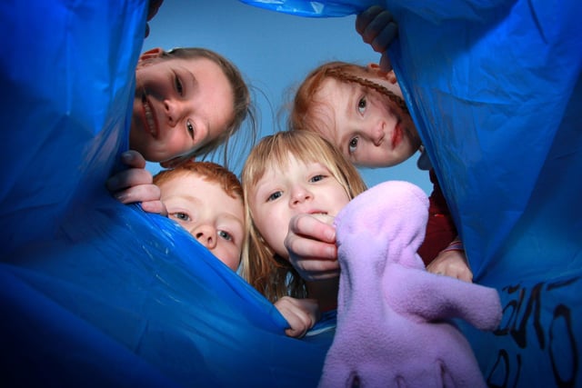 Glaisdale School pupils place clothes in a bag ready for a charity collection.