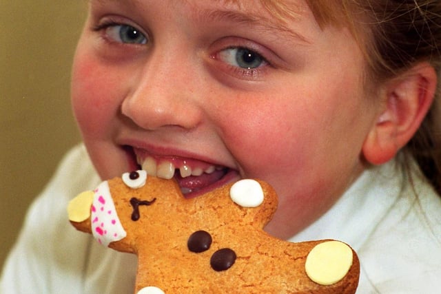 This is Chloe Gelder a pupil at Leeds Girls School with one of the Pudsey Bear biscuits she is selling for Children in Need in November 1995. It was her fifth year raising cash for Children in Need.