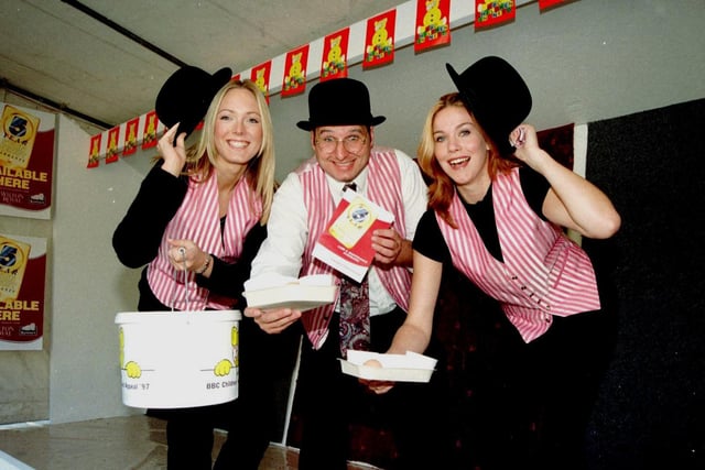 James Taylor of Carpets International with Leeds promotion girls Sarah Dawson (left) and Lucy Hunter, who were encouraged people to throw eggs at carpet samples for Children in Need in September 1997.