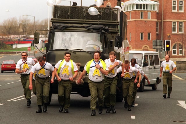 Members of the 49 (West Riding) Signal Squadron (volunteers), from Carlton Barracks Territorial Army Centre pull a radio relay vehicle during their sponsored truck pull through Leeds in November 1995.