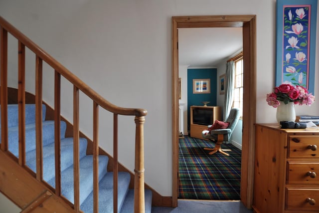 A glimpse of the house interior with its carpeted wooden staircase.