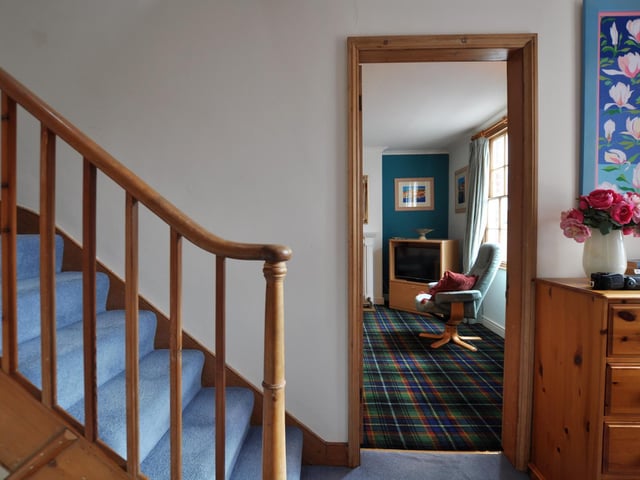 A glimpse of the house interior with its carpeted wooden staircase.