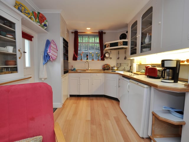 Fitted units line the kitchen walls giving plenty of storage space.