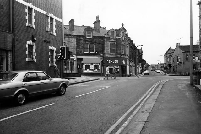 October 1980 and this view looks from High Street toward the junction with South Queen Street, Fountain Street and Queen Street. On the left is the Pavilion Bingo and Social Club. Across the road is a butcher's shop, then James Ashley, Menswear, which is advertising a closing down sale and is partially boarded up. On the right is the Fountain Inn.