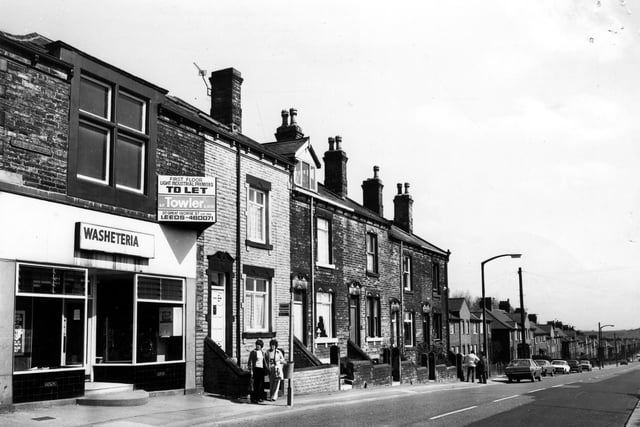 Middleton Road in April 1981 showing a parade in the foreground consisting of a launderette, with industrial premises on the first floor advertised for let and a fish and chip shop.