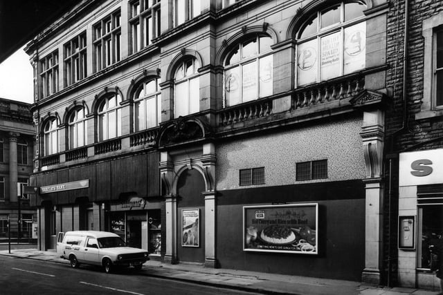 The former Morley Industrial Co-operative Society Ltd. building on Albion Street by the junction with Queen Street, left. This listed building dating from 1899 is pictured in March 1982 occupied by Barclays Bank and Candyman tobacconists and confectioners.