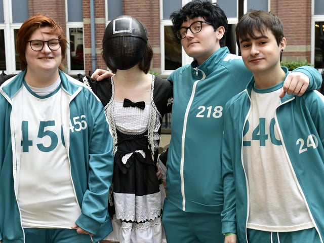 Friends dressed as squid game characters