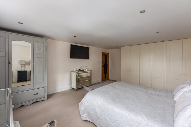 Space features in this large double bedroom with fitted furniture.